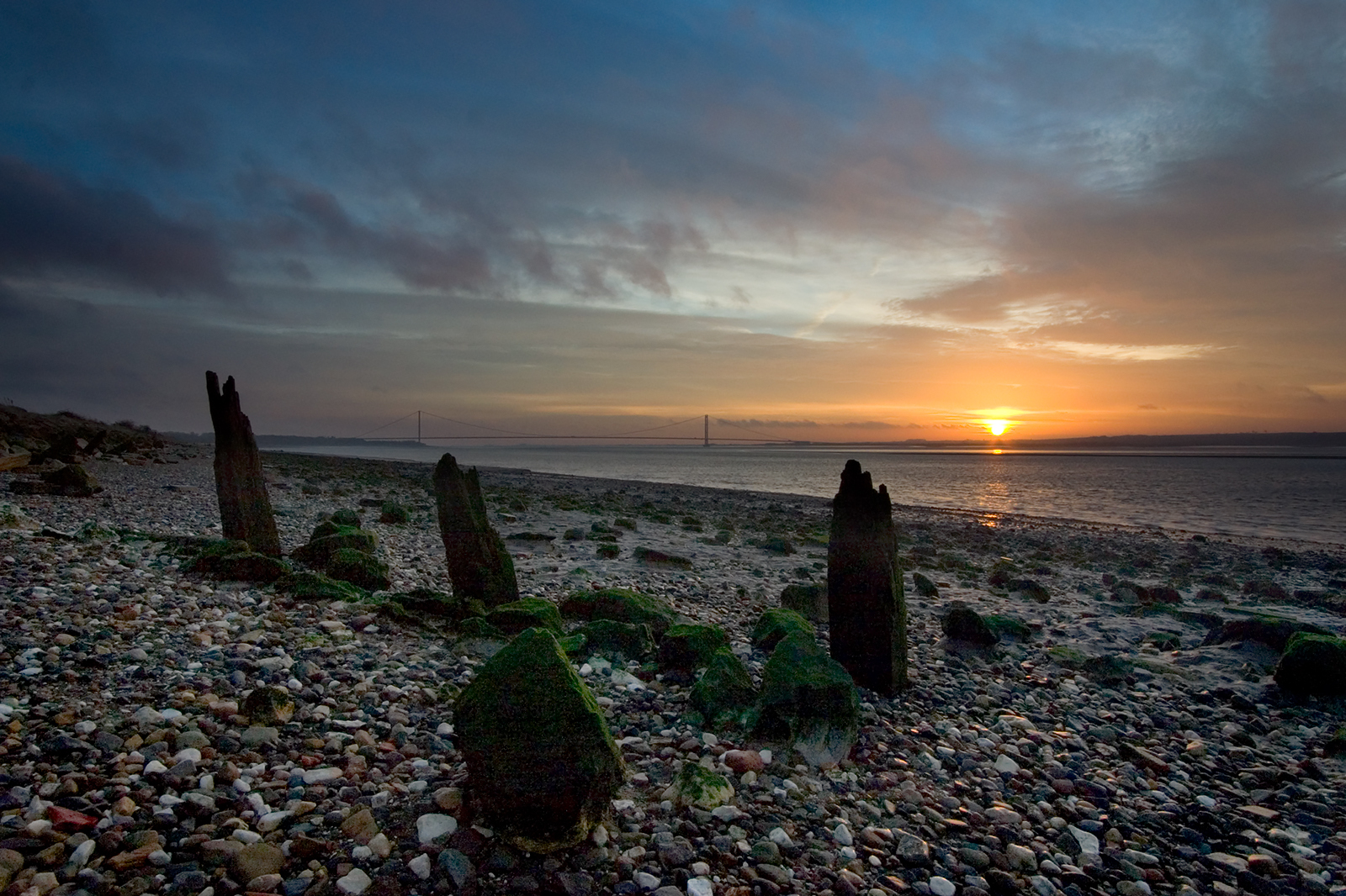 Photograph of the sunrise over the Humber Bridge from North Ferriby foreshore